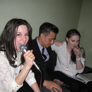 a woman singing into a microphone