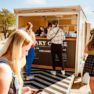 a group of people standing in front of a truck