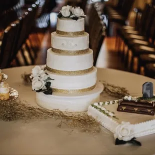 a wedding cake and cupcakes