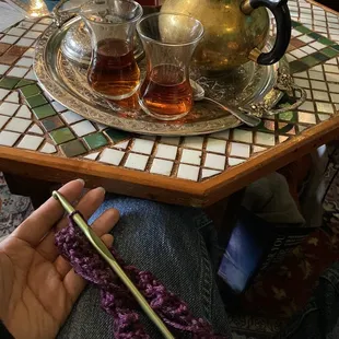 a person knitting a scarf