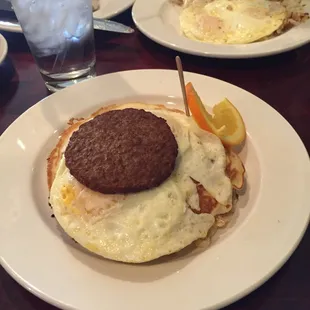 Chocolate chip pancakes, eggs over medium and turkey sausage.