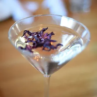 a martini glass with a flower in it
