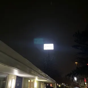 a street sign lit up at night
