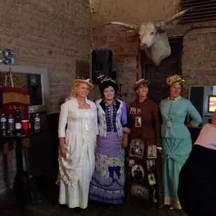 a group of ladies dressed in period costumes