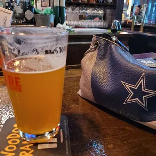 a pint of beer on a bar