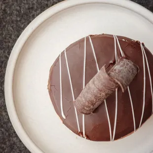 a chocolate donut on a plate