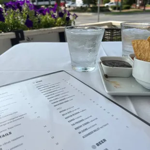 a menu and a glass of water