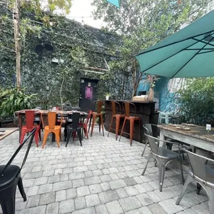 a patio with tables and chairs