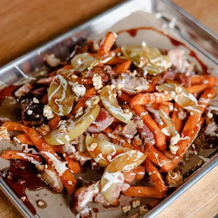 a tray of cooked carrots and onions