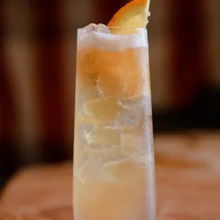 a closeup of a drink with a slice of orange