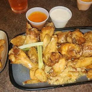 a tray of chicken wings and french fries