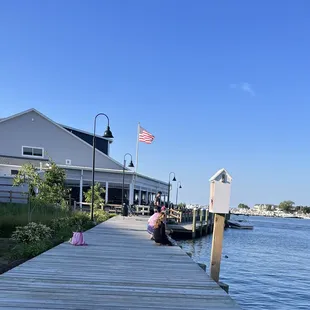 a woman sitting on a dock