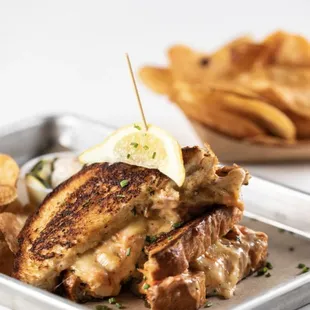 a grilled chicken sandwich and chips