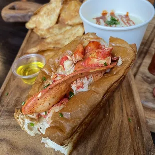 a lobster sandwich on a wooden cutting board