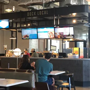 people sitting at tables in a restaurant