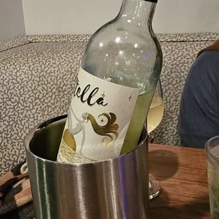 a bottle of white wine in an ice bucket