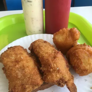 Small fish sandwich with hush puppies.