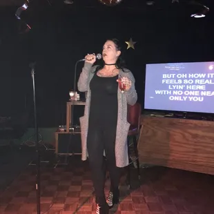 a woman singing into a microphone