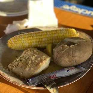 Mahi mahi with baked potato and corn