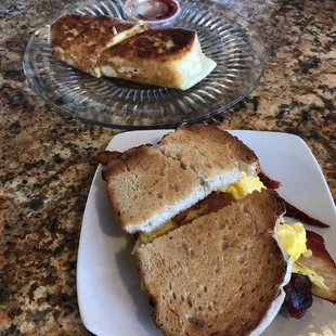 a sandwich and bacon on a plate