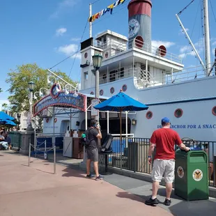 people standing outside of a restaurant