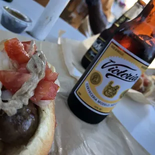 a bottle of beer and a hot dog