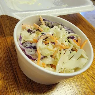 a white bowl of coleslaw and carrots