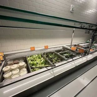 a salad bar with a variety of salads
