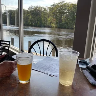 a person sitting at a table with a glass of beer