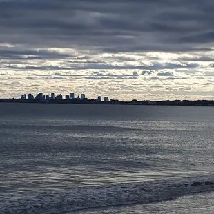 View of ocean and Boston skyline across the street.