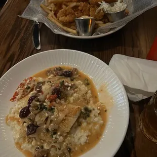 Bottom is Mediterranean Haddock on parmesan risotto--top is fried shrimp &amp; scallops
