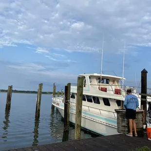 The charter and a deckhand cutting bait.