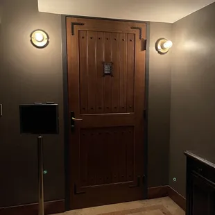 a wooden door and floor lamp