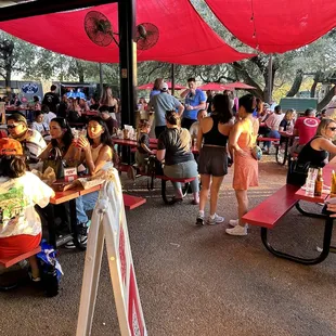 Patio area with people standing and waiting