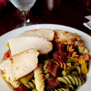 a plate of pasta with meat and vegetables