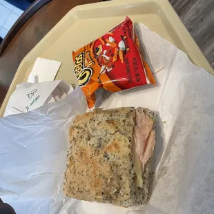 a sandwich and chips on a tray