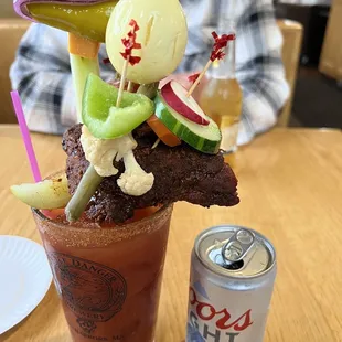 Bloody Mary with Bacon, salami, olive, cheese, egg, celery, BBQ ribs, peppers, pickle, and veggies.