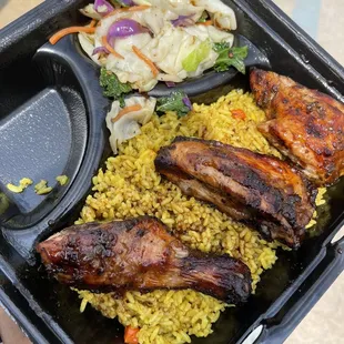 Jerk chicken platter w/ island rice and cabbage.