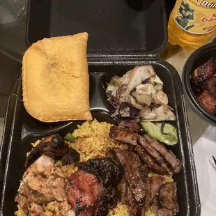 Combination platter with jerk chicken, jerk pork, island rice, cabbage and beef patties.