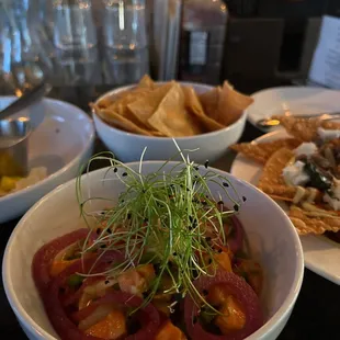 Happy hour feast ceviche, calamari, and gourmet nachos