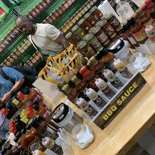 a man standing in front of a table full of jams