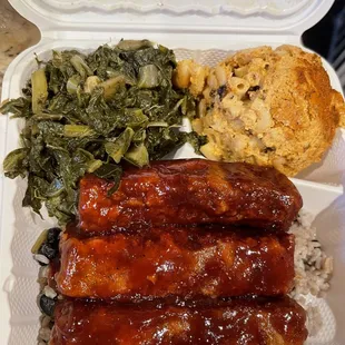 Bbq ribs over rice and peas , seafood mac , collard greens