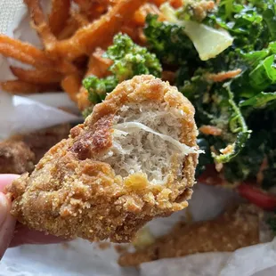 Entree and two sides - "chicken drummies", garlic kale salad, and sweet potato fries