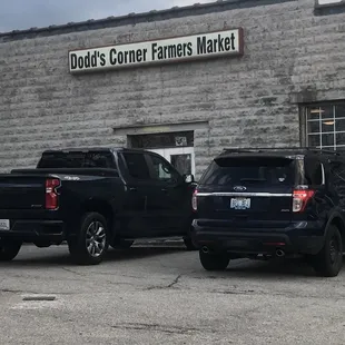 two trucks parked in front of a building