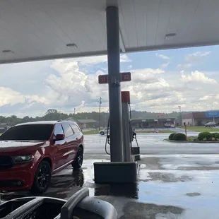 a red car at a gas station