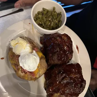 Half rack of ribs with baked potato and green beans