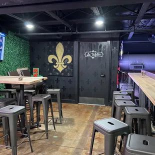 a bar with stools and a television
