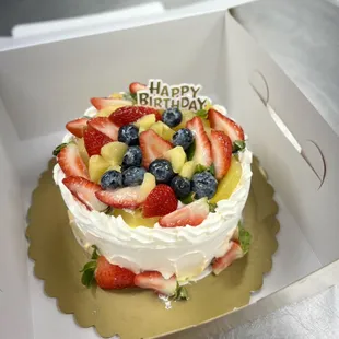 A 6&quot; birthday cake with extra extra fruit on top by Dodo Bakery!