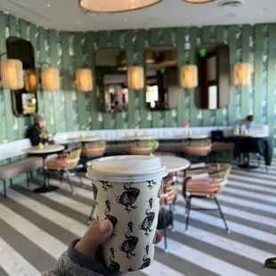 a person holding a coffee cup