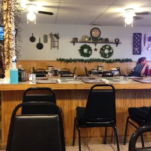 a restaurant with a counter and chairs